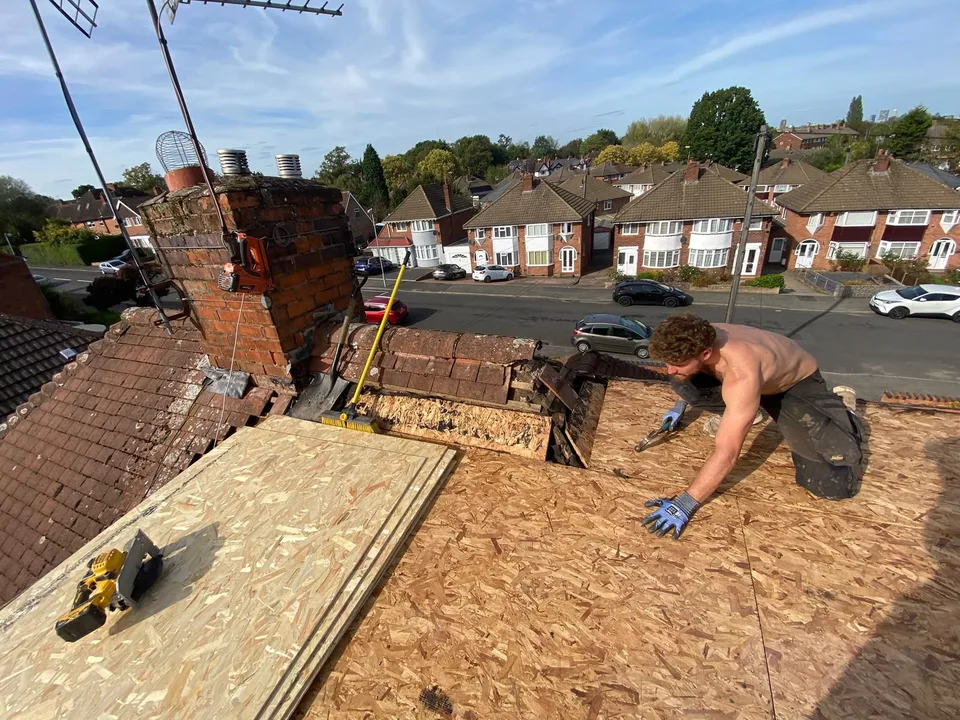 Roofer fitting decking on the featured flat roof, work in progress