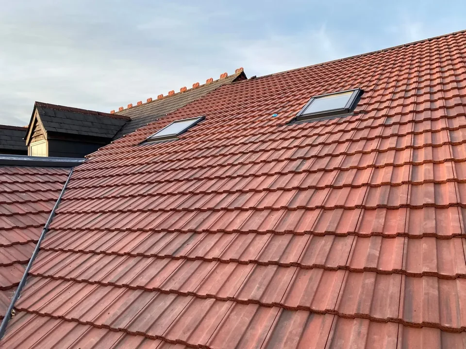 Completed tiled pitched roof with two roof windows.
